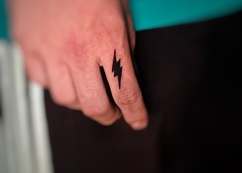 man-lightning-finger-tattoo-black-