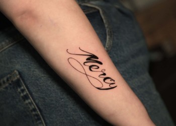 woman-arm-tattoo-mercy-black