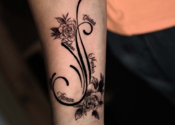 woman-arm-tribal-tattoo-black-roses