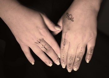 woman-hand-tattoos-fine-line-smallies-moon-shapes-dots-black-