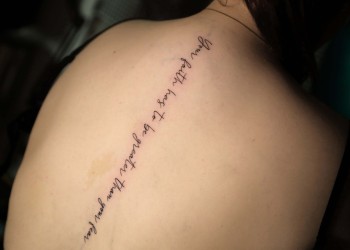 woman-spine-lettering-back-tattoo-fineline-