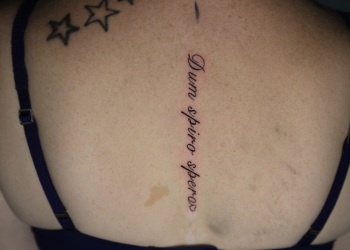 woman-spine-lettering-tattoo-black-fineline-